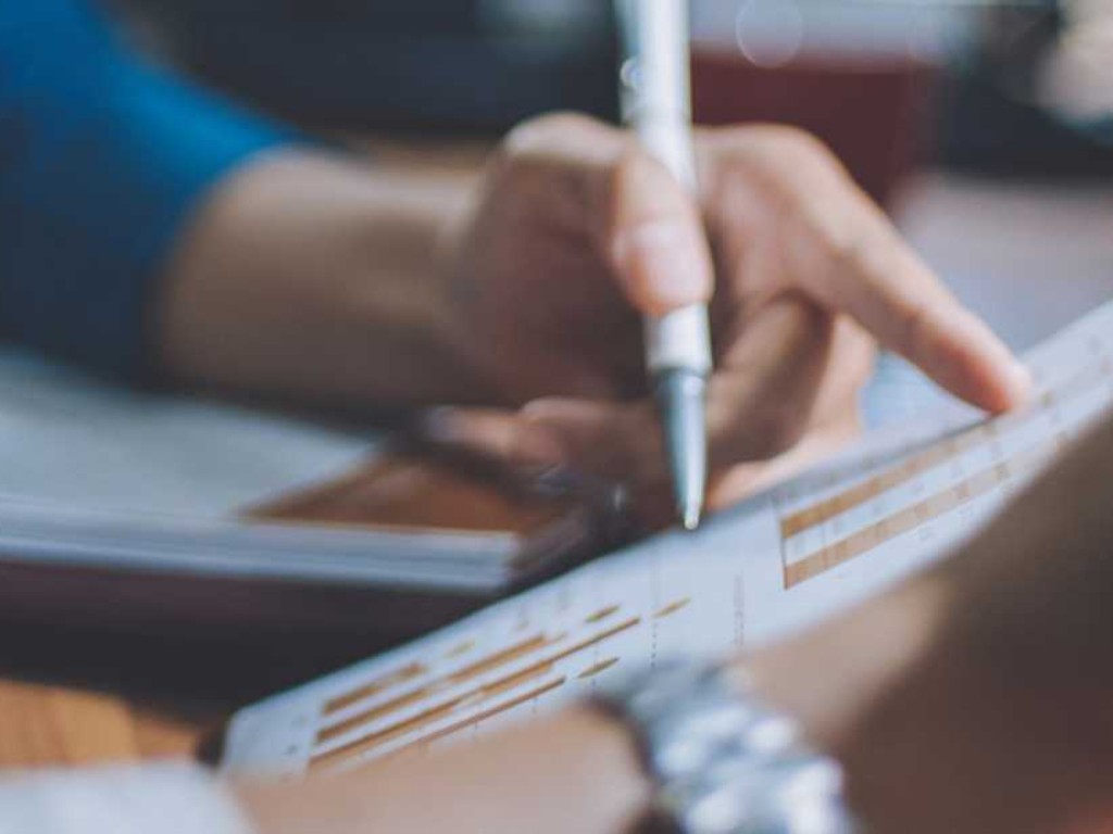 People reviewing charts and taking notes